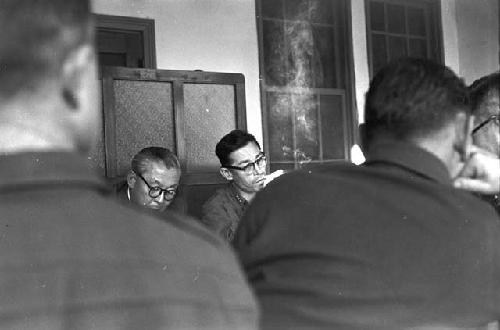 Portrait of suits at table smoking during meeting