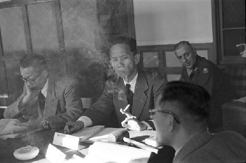 Portrait of man smoking cigarette at table