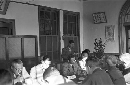 Portrait of men during meeting going over papers