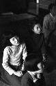 Children kneeling on floor looking ahead singing