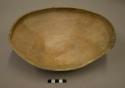 Partial undecorated pottery bowl