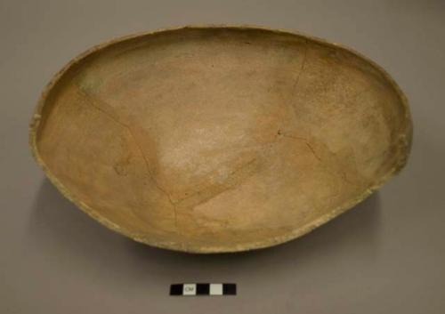 Partial undecorated pottery bowl