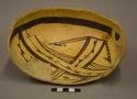 Two thirds black on yellow pottery bowl--restored