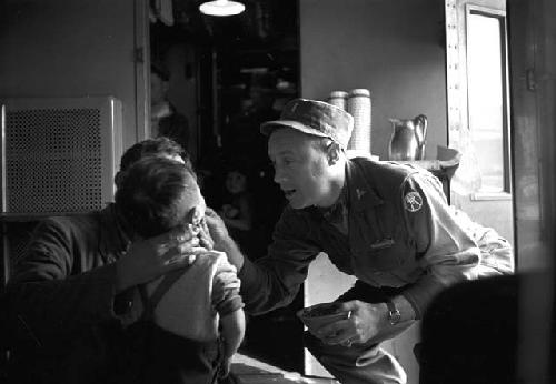 Boy being treated by soldier