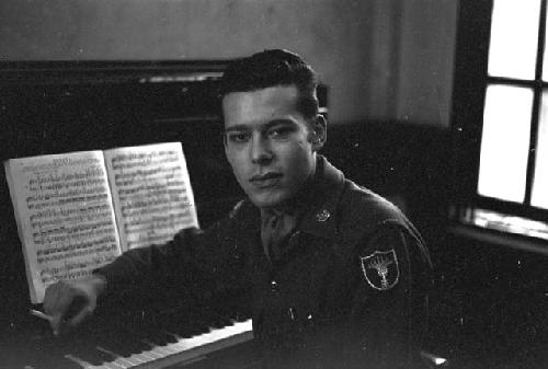 Officer smoking cigarette next to piano