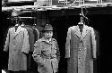 Man standing by coat racks