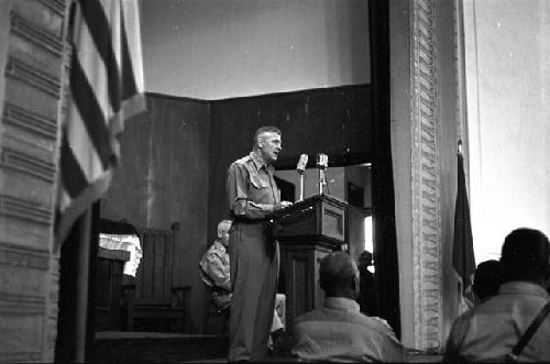 Portrait of soldier at podium adressing audience