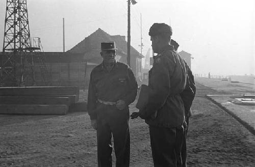 Soldiers meeting outside near base