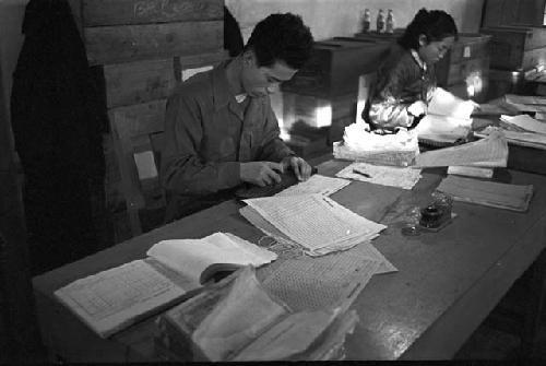 Workers going through papers on large table