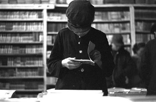 Young boy flipping through book