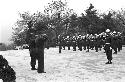 Portrait of soldier slaute and band playing