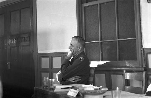 Soldier sleeping on bench during meeting