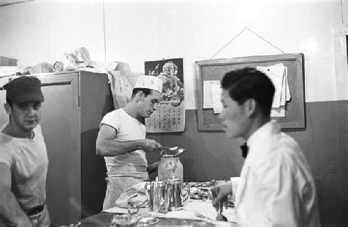 Chefs and bus boys prepping in kitchen