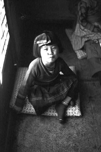 Portrait of girl with piece of clothing on head 2