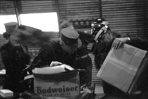 Soldiers opening boxes at base