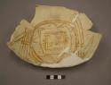 Fragments of large black on yellow pottery bowl
