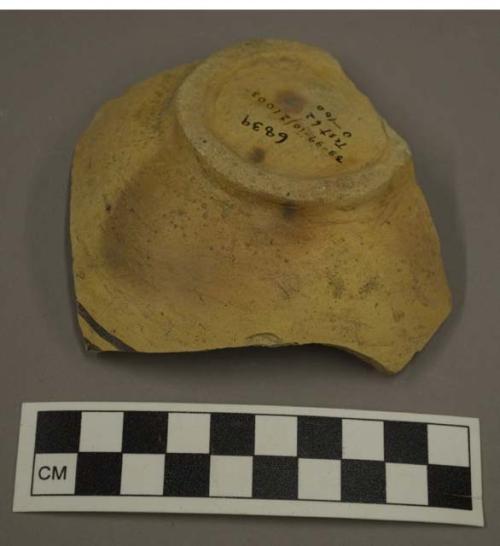 Black-on-yellow potsherd with ring base