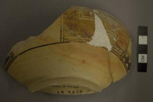 Restored fragment of polychrome pottery bowl with ring