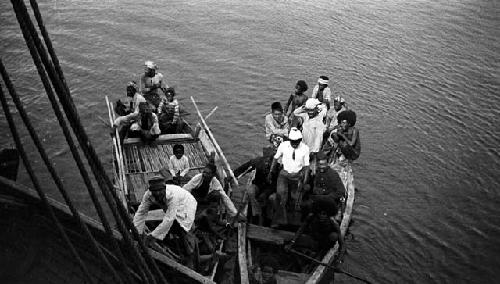 Two rowboats full of men and children