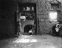 Turfan, Grape Valley, two children standing in mud brick room