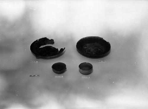 Coarse orange ware basin, green glazed pottery dish, and two shallow vessels