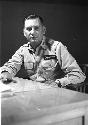 Soldier sitting on chair with cigarette in his hand