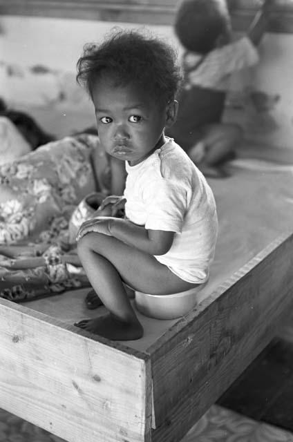 Portrait of baby sitting on baby stool