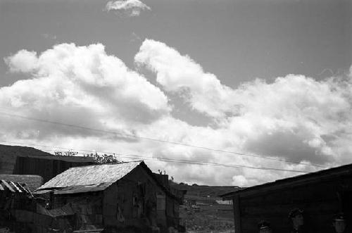 View of houses and rising hill in background