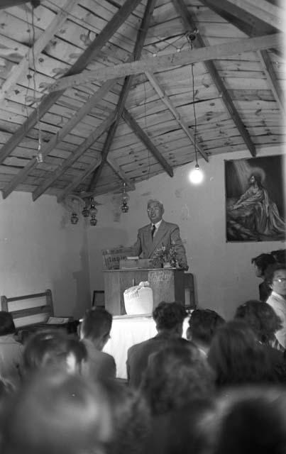 Minister at podium in church as people watch