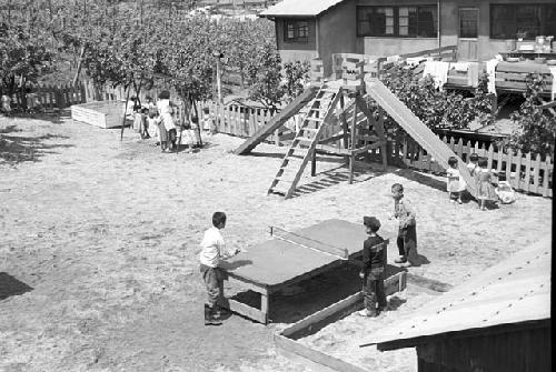 Aerial view of kids playing table tennis in playground