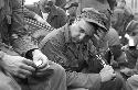 Soldiers sitting down bunched together