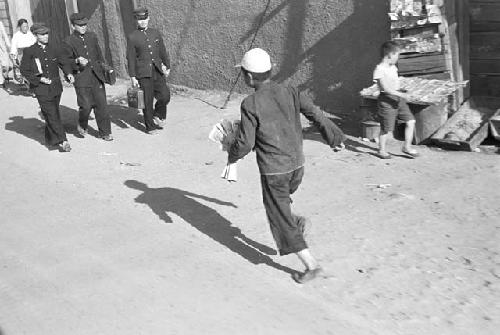 Boy running with newspaper in hand