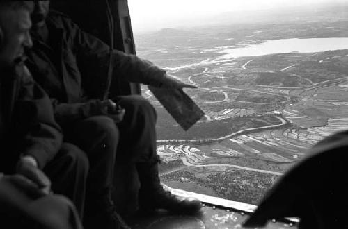 Soldiers in air craft looking down at country
