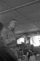 Soldier at head table addressing everyone inside banquet room