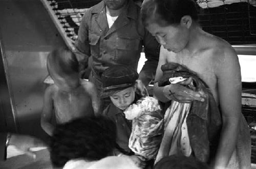 Children in line receiving clothes