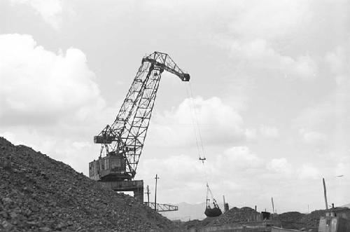 Crane hauling pile of rocks