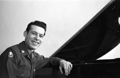 Portrait of officer with arm rested on piano