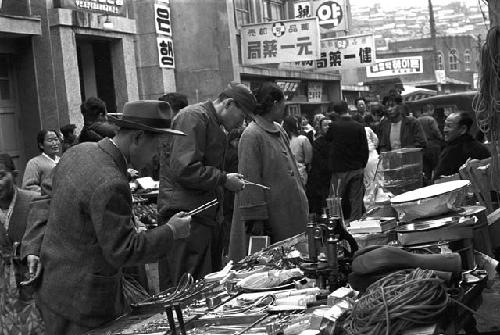 Civilians walking through market place