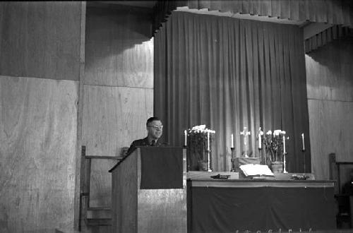 Paostor/Priest preaching at podium