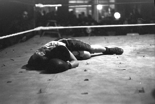 Boxer laid out on canvas in ring