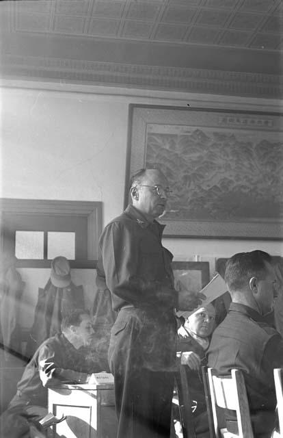 Soldier standing at table during meeting