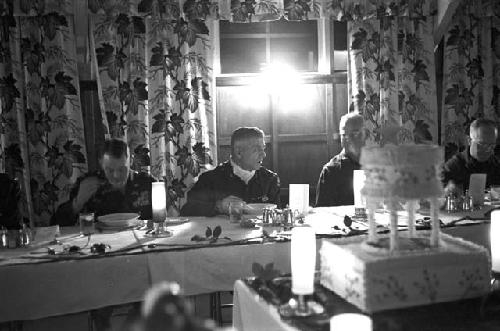 Portrait of general and soldiers eating dinner