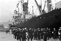 Navy soldiers walking towards ship entrance