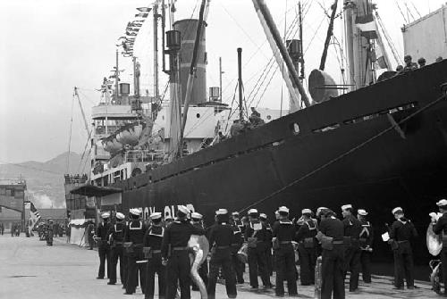 Navy soldiers walking towards ship entrance