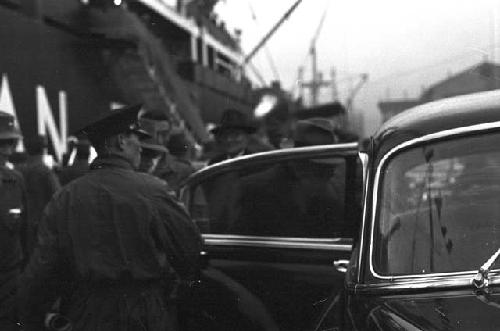 Soldiers exiting car by ship from back