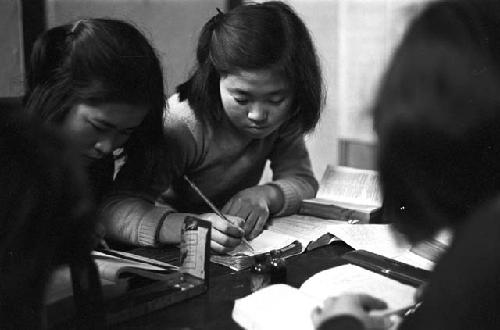 Children at table working on assignment