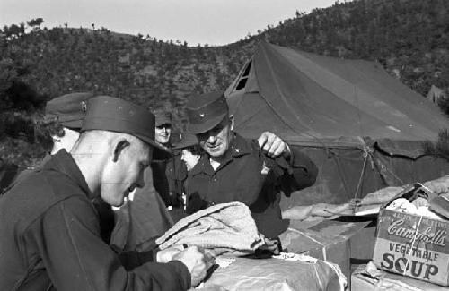 Soldiers by boxes stocking on goods