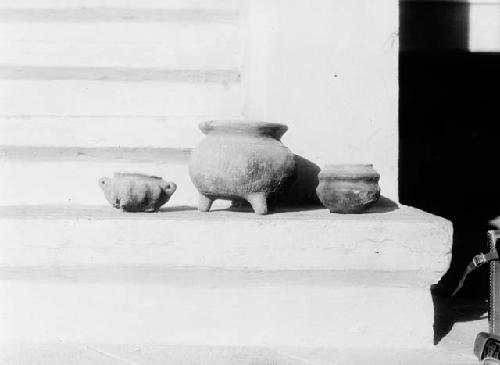 Two scarified ware tripods and one red ware jar