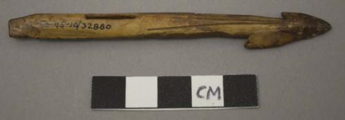 Ivory harpoon point, barbed and incised, narrow rectangular perforation