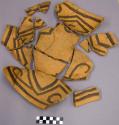 Sherds of black on orange bowl with interior linear wall pattern
